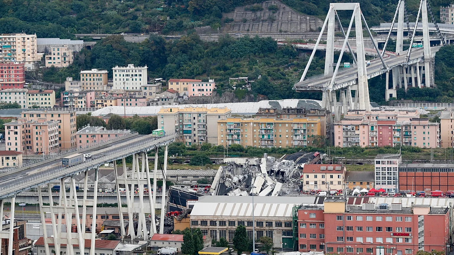 Cars stranded on the Morandi motorway viaduct after part of it collapsed, on 14 August 2018, in Genoa, northern Italy. (AP Photo/Antonio Calanni, file)