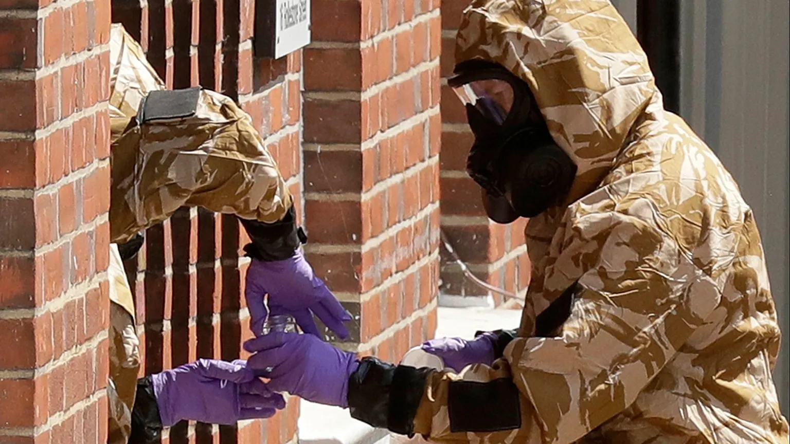Specialist team members in military protective suits during Novichok nerve agent clean-up operations in Salisbury, 6 July, 2018