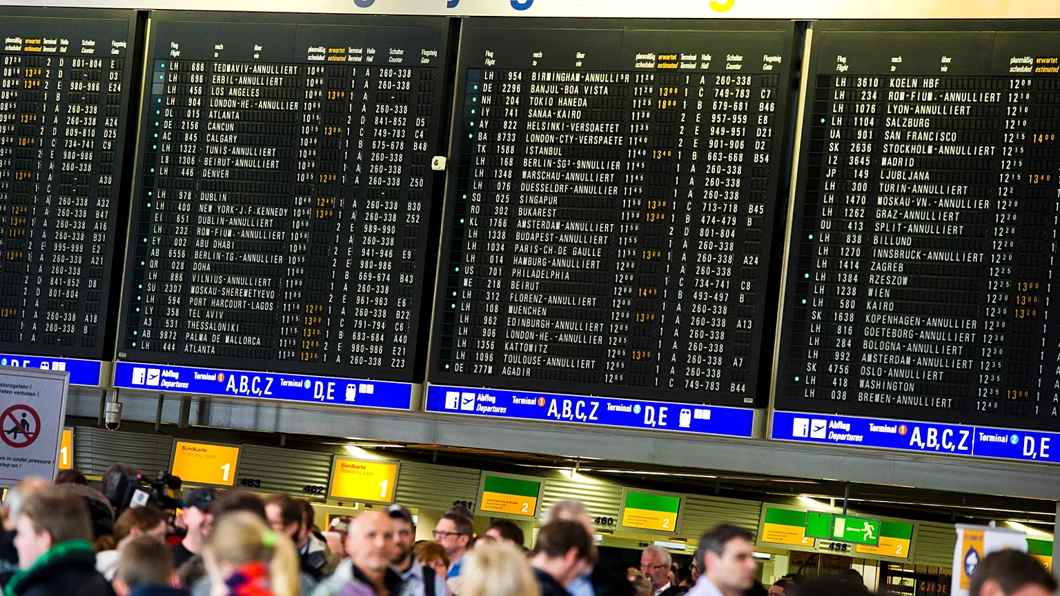Passengers stand in the terminal of the airport in Frankfurt Main, Germany, Tuesday March 12, 2013.