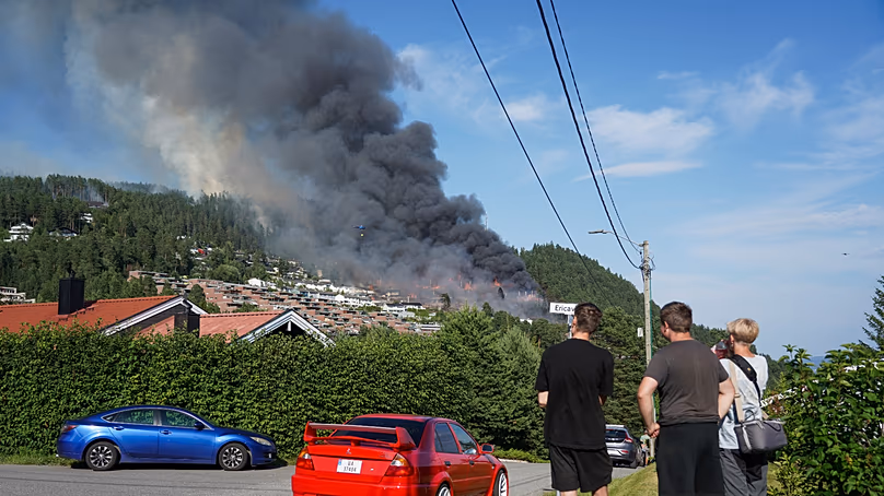 Smoke rises over terraced houses on fire in the Krokstadelva village in Drammen, Norway, Friday. July 17, 2026. (Thomas Fure/NTB Scanpix via AP)