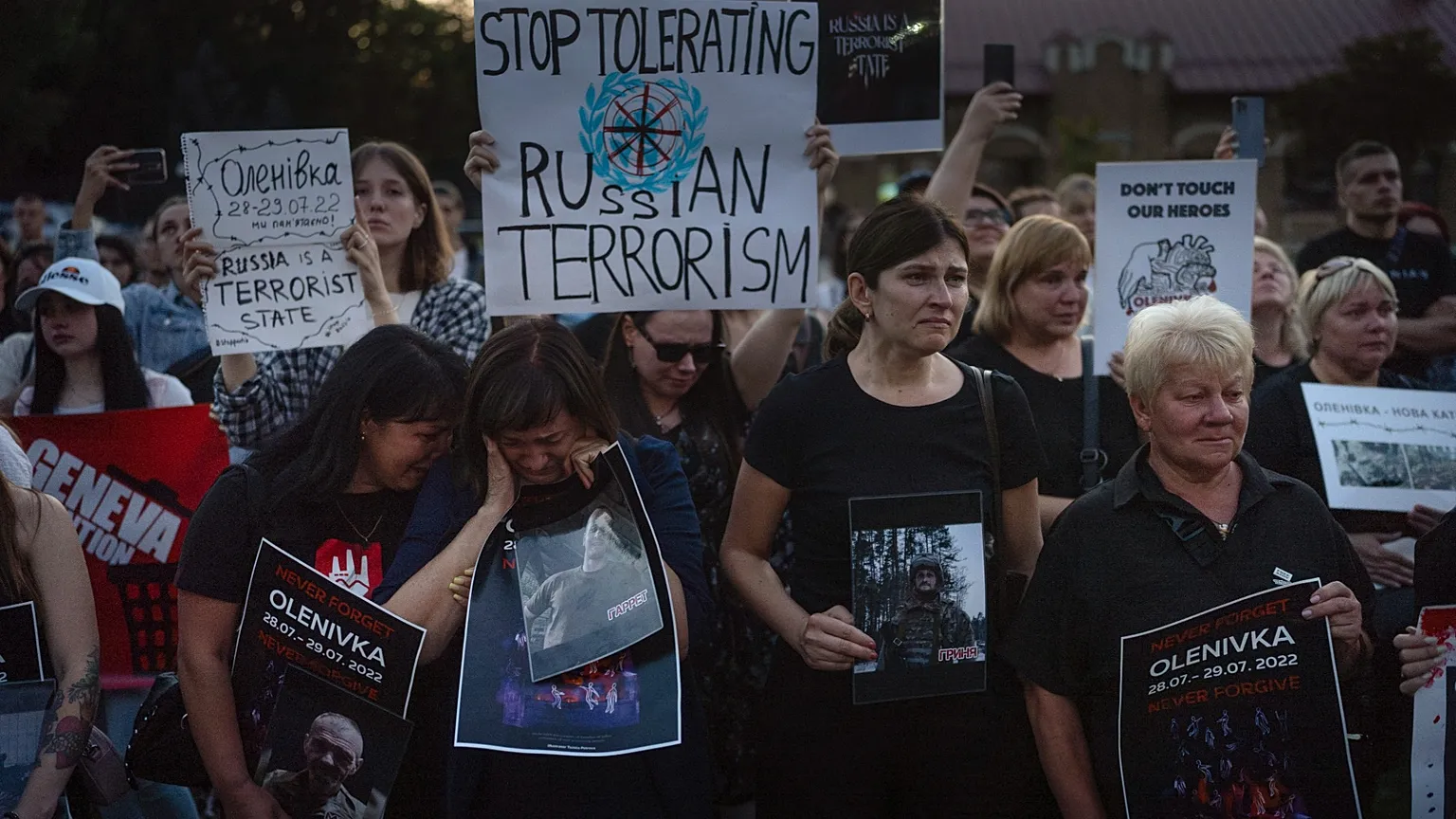 People hold signs outside the Russian embassy in Kyiv, 29 July, 2023