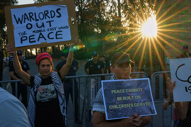 Protesters hold placards during a protest against the Board of Peace in Nicosia, 30 June, 2026