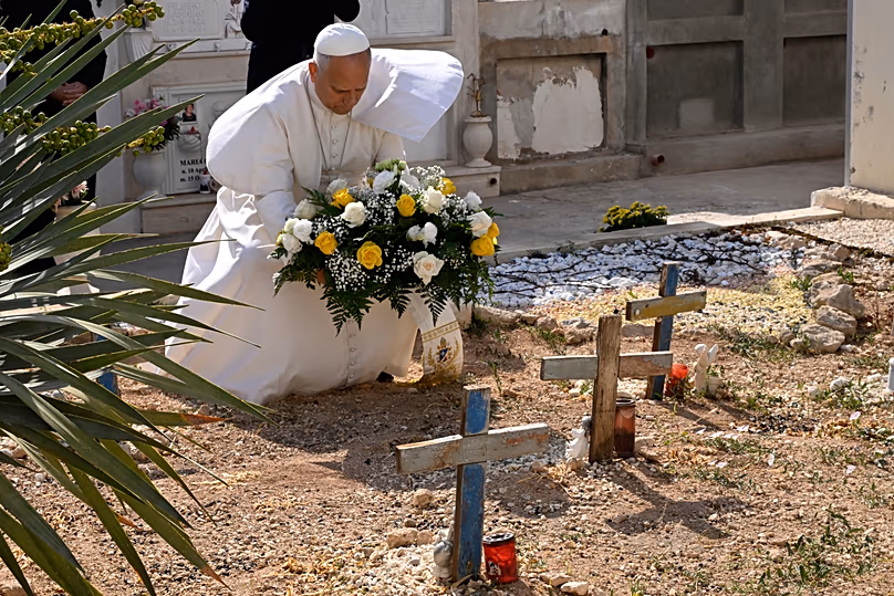 Pope Leo prays over migrants' graves, crosses fashioned from the wood of the boats