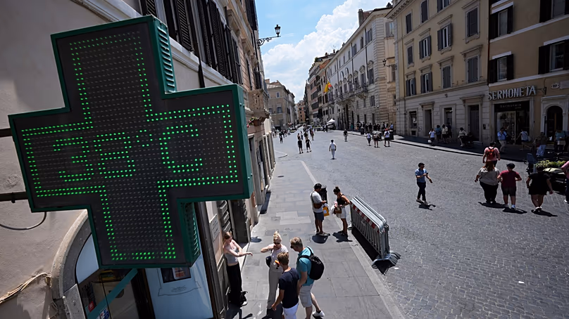 The thermometer of a drugstore shows the temperature of 38 degrees Celsius as temperatures reach record highs, in Rome, Wednesday, June 24, 2026. (AP Photo/Andrew Medichini)