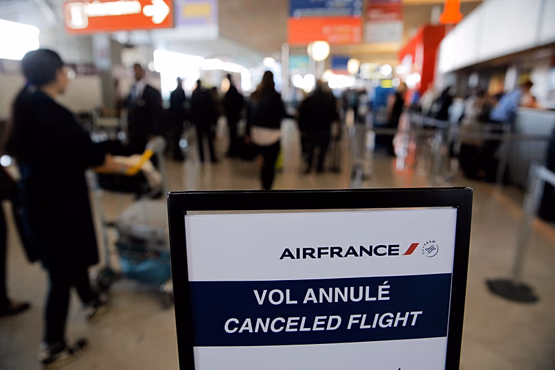 APA traveller walks past a board reading "canceled flight", at Paris Charles de Gaulle airport, in Roissy, near Paris Photo