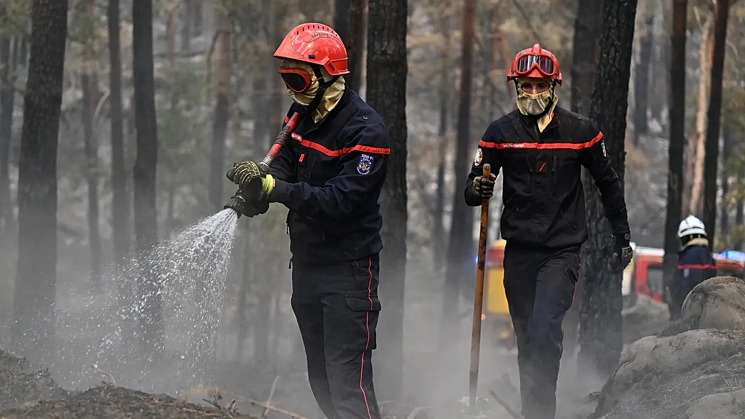 Firefighters tackle a wildfire in the region of the Fontainebleau forest, south of Paris, France, Tuesday, July 14, 2026. 