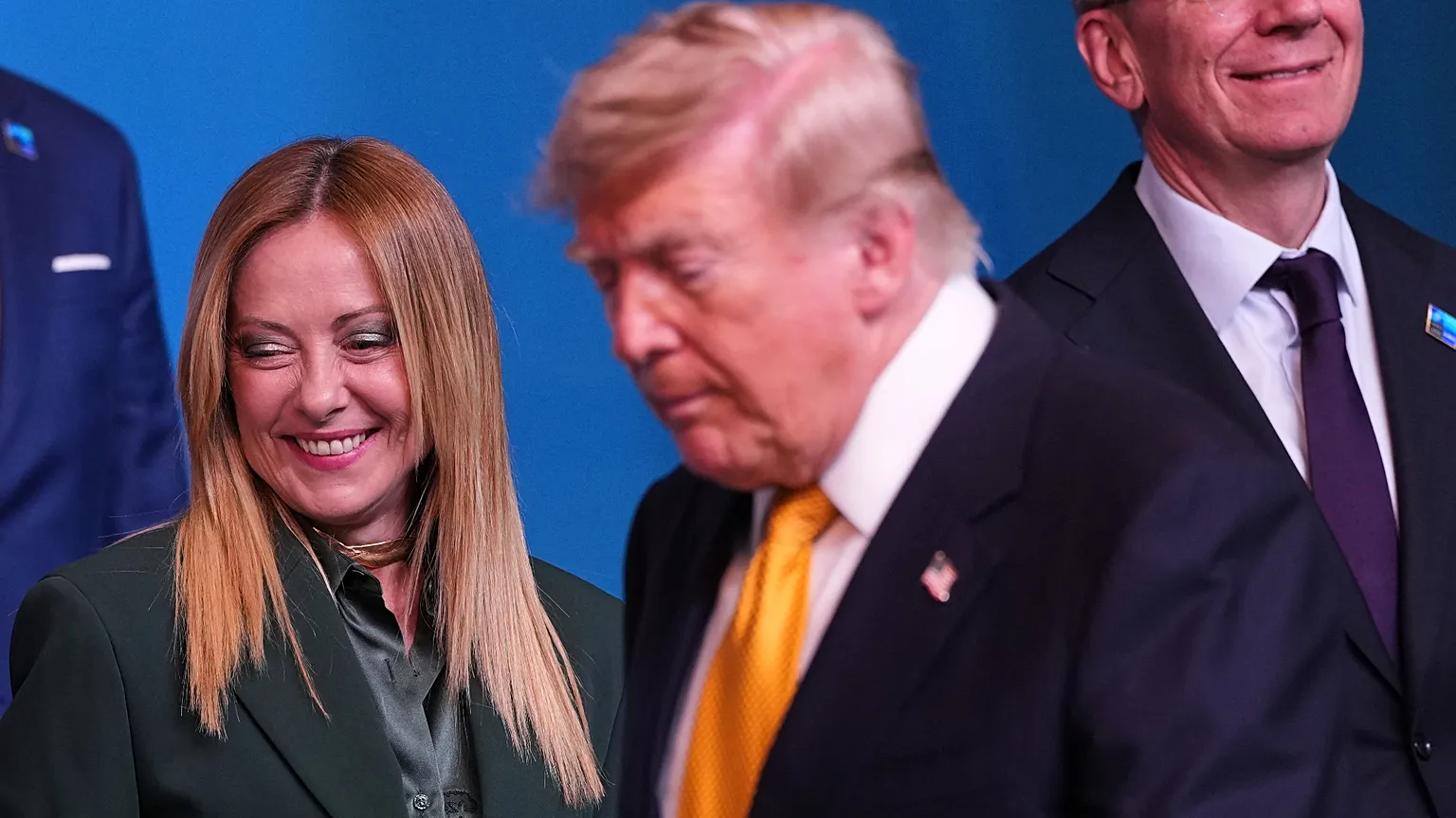 President Donald Trump walks over to stand next to Italian Prime Minister Giorgia Meloni, left, for the group photo during the NATO summit in Ankara, Turkey.