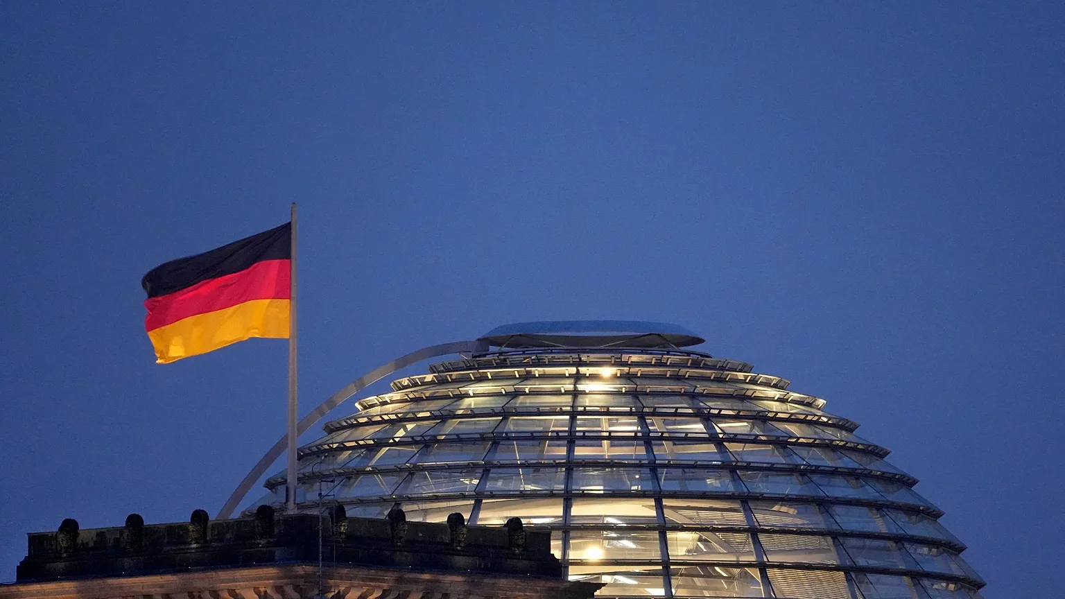 A German flag waves on top of the Reichstag building, home of the German federal parliament, Bundestag, in Berlin, Germany, Thursday, Nov. 18, 2021. 