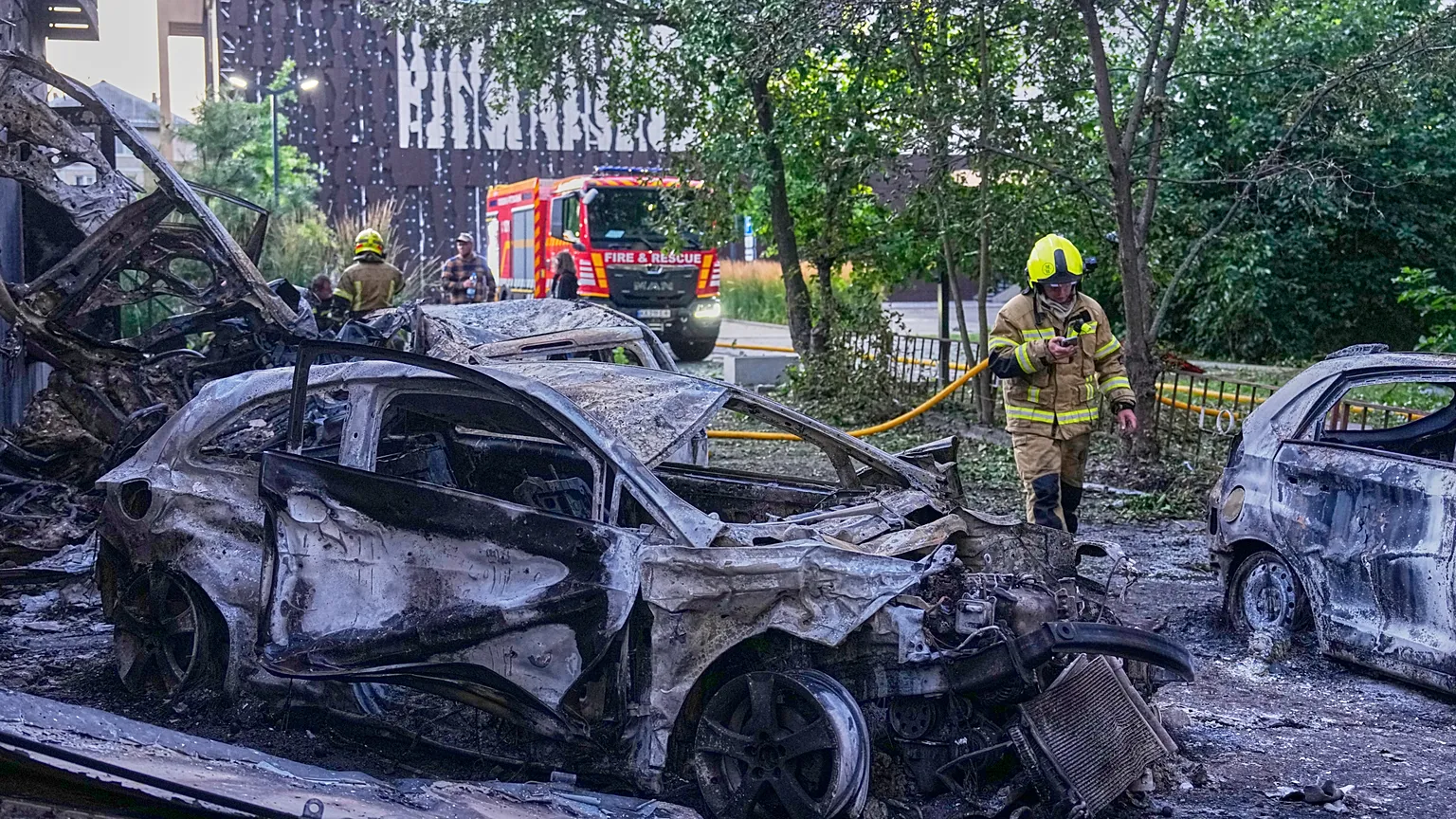 A firefighter puts out a fire following a Russia missile attack in Kyiv