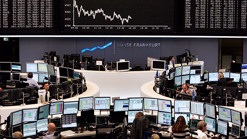 Brokers are seen under the curve of German stock index DAX at the stock market in Frankfurt, central Germany, Monday, Oct. 20, 2008.