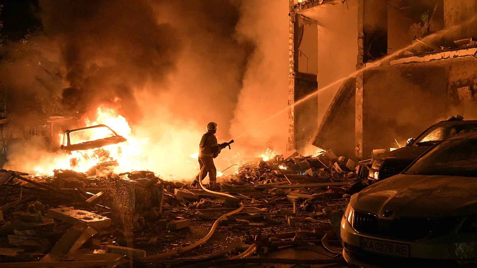 Emergency services personnel work to extinguish a fire following Russian missile attacks in Kyiv, Ukraine, Monday, July 6, 2026.