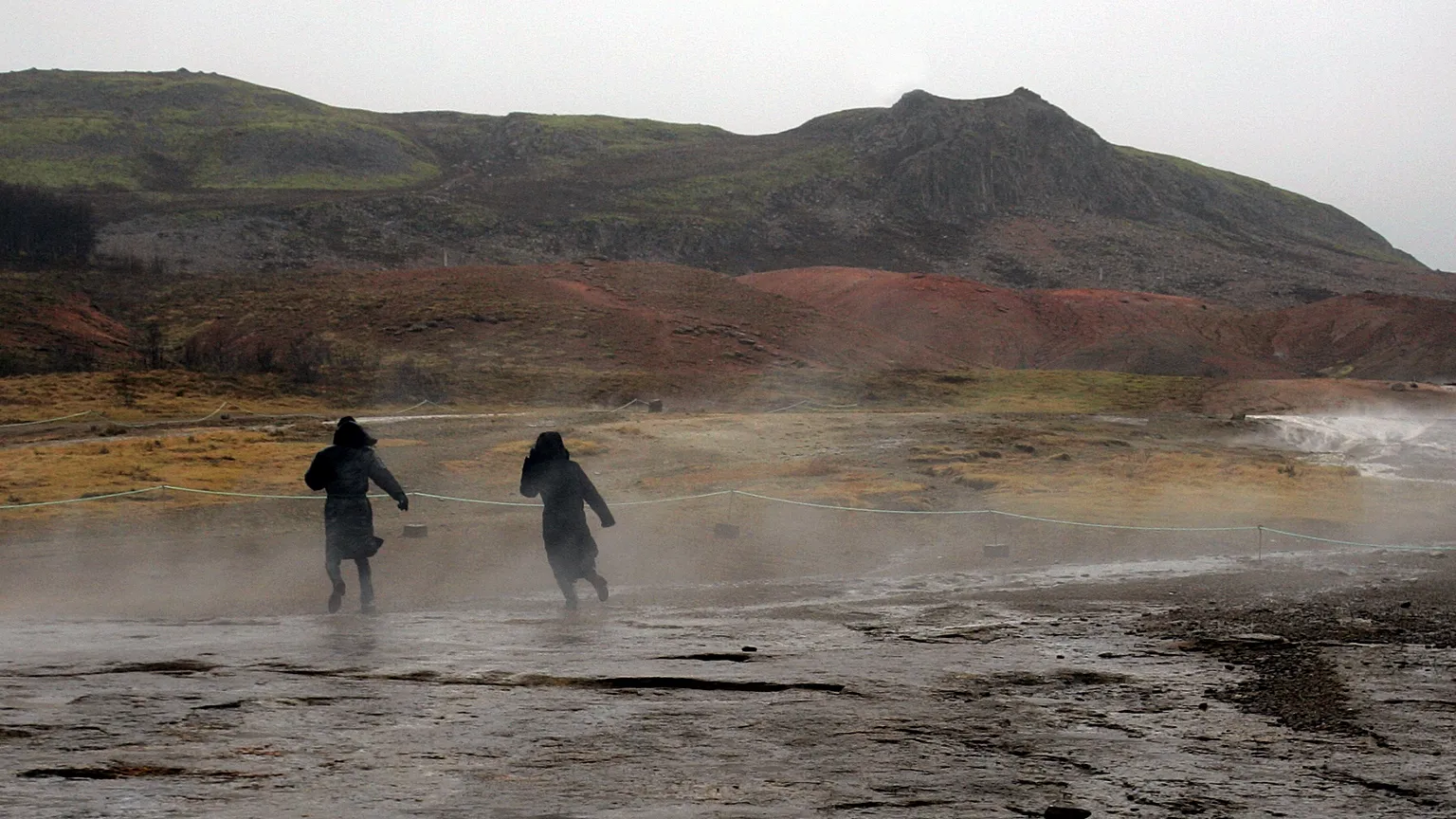  FILE ** In this Feb. 22, 2006 file photo tourists brave the weather to walk around the hot springs area at the site of Geysir, Iceland. (AP Photo/Kirsty Wigglesworth, File)