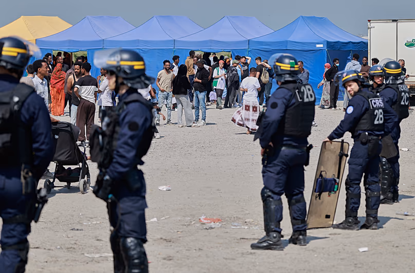Police conduct a search operation at a makeshift camp of migrants who want to cross the English Channel to Britain near Dunkirk, 27 May, 2026
