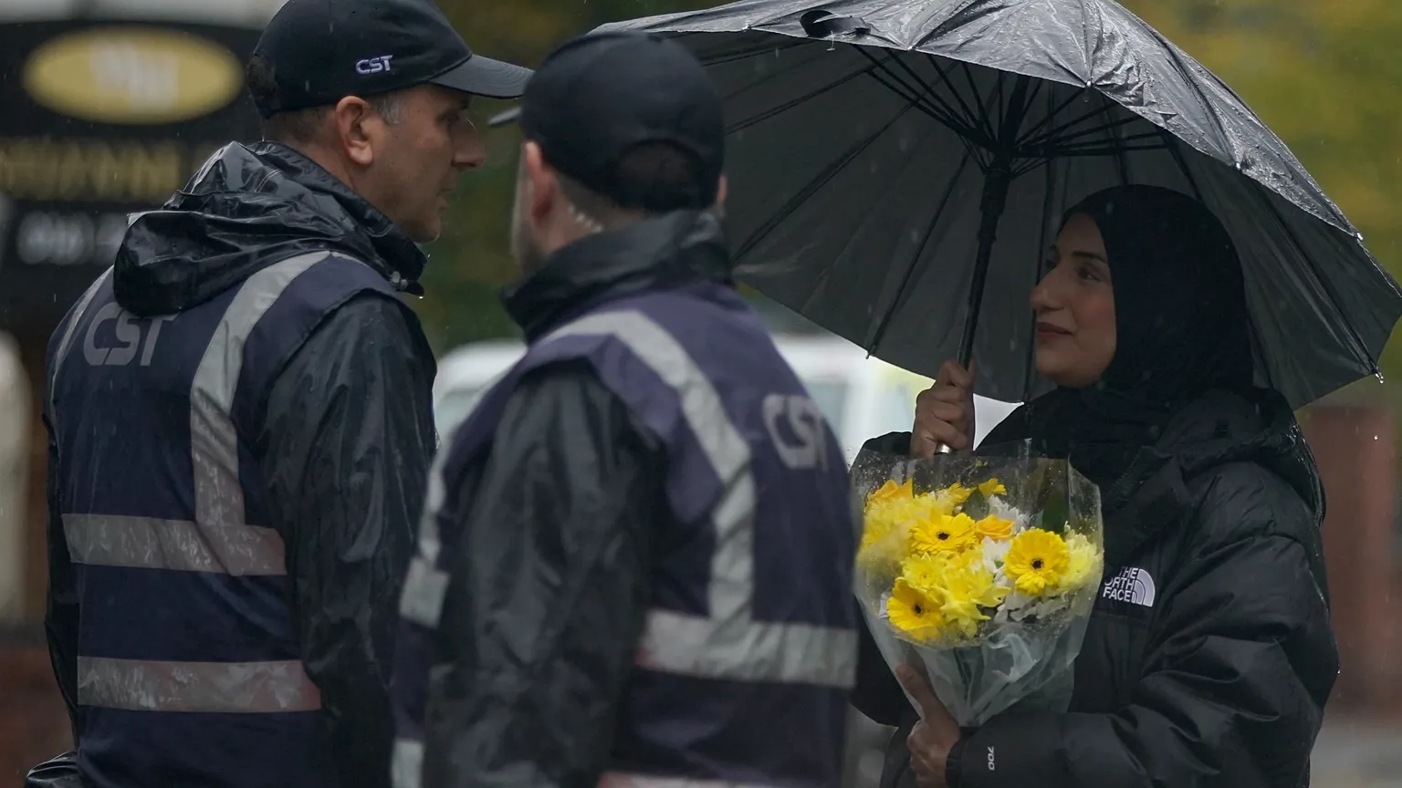 A woman carrying flowers attends a vigil for the victims of the attack at Heaton Park Hebrew Congregation synagogue in Manchester, England, Friday, 3 October 2025.