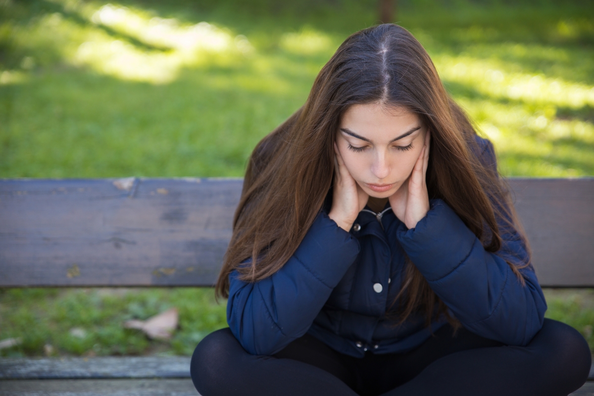 Una mujer espera triste en un banco (Magnific)