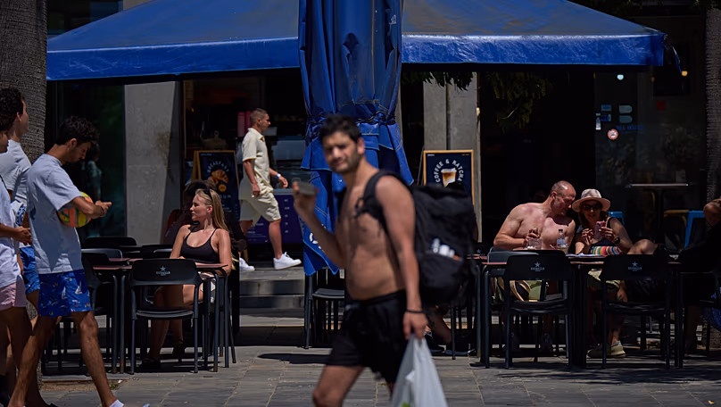 Customers sunbathing whilst having a drink on a terrace in Barcelona, 27 May, 2026