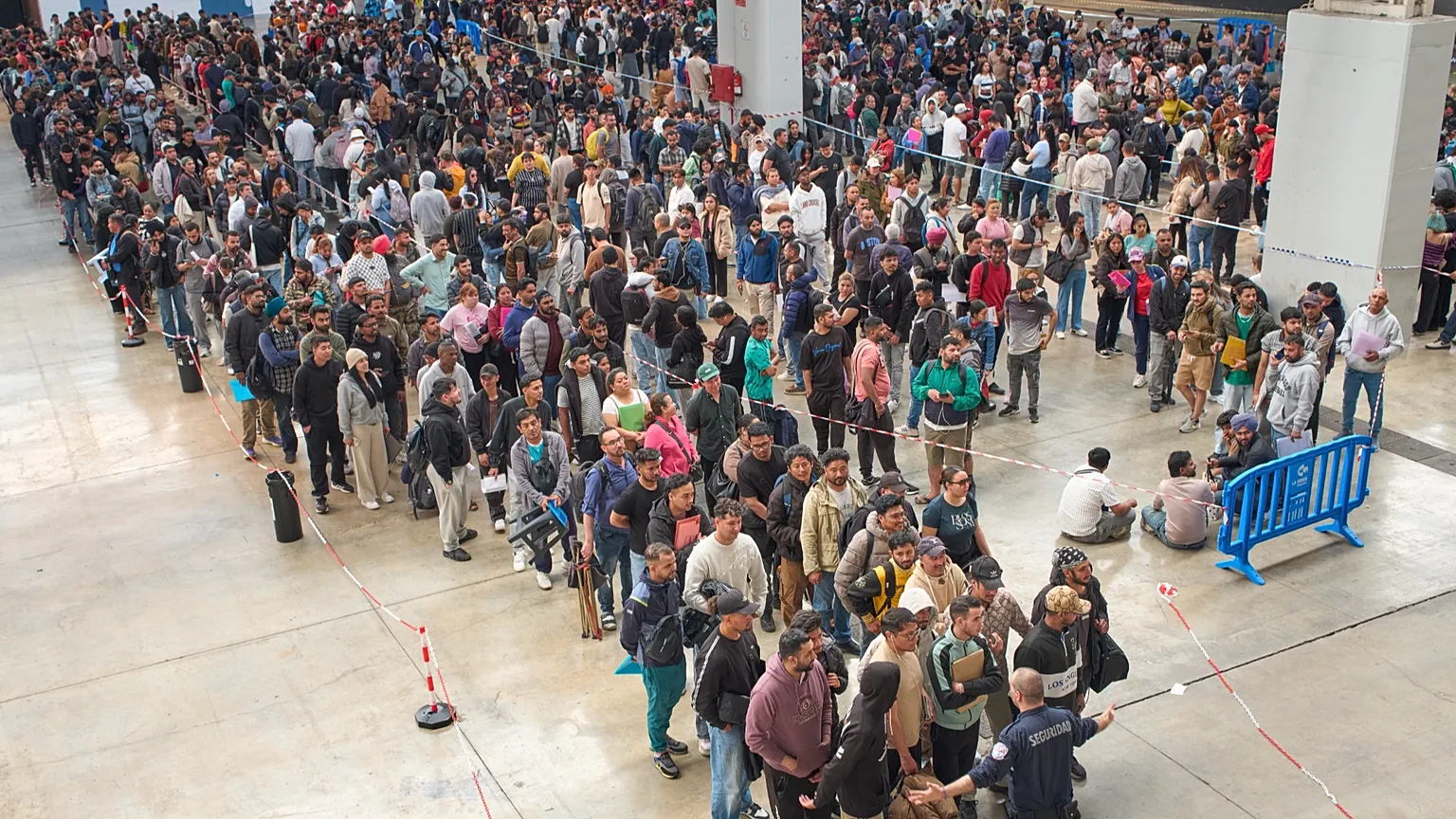 Migrants queue at a public service office to obtain paperwork needed to apply for Spain's immigration amnesty near Barcelona, 21 April, 2026