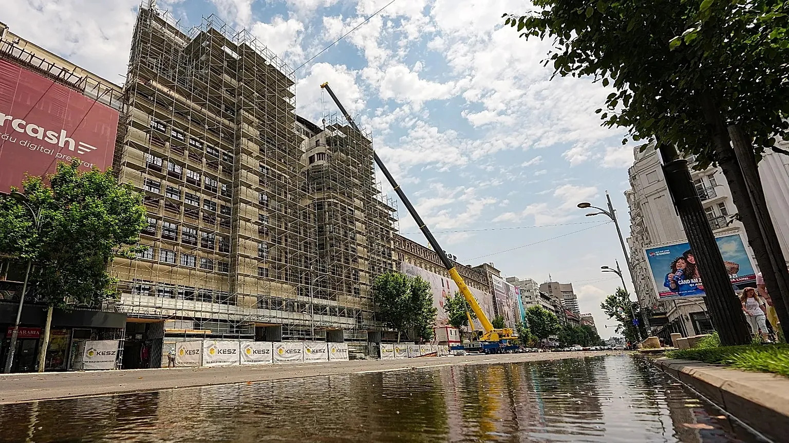 A portion of a main boulevard, with one lane flooded is blocked for traffic by police due to risk of roof collapses, in Bucharest, Romania, Wednesday July 1, 2026.