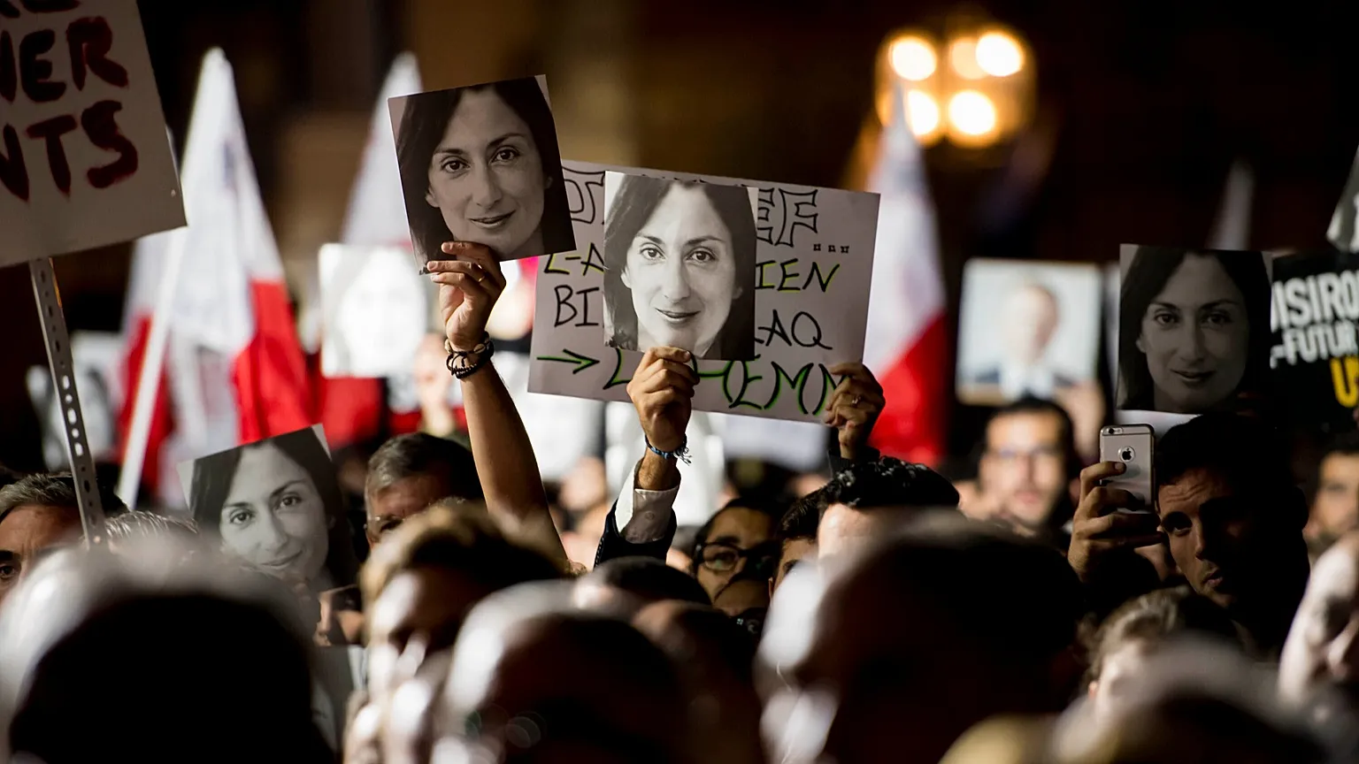 Protesters hold photos of Daphne Caruana Galizia during a protest in Valletta, 29 November, 2019 