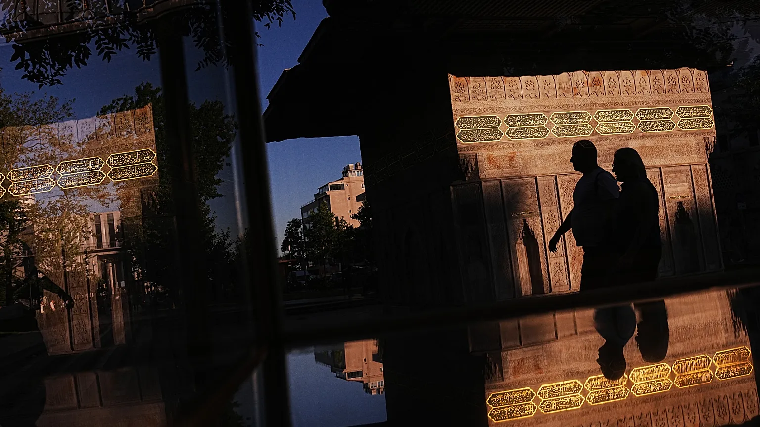 People walk past the Ottoman-era style Tophane public fountain in Istanbul, Turkey, Sunday, July 12, 2026.