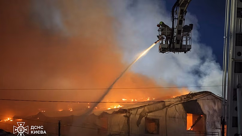 Emergency services personnel work to extinguish a fire following a Russian air attack in Kyiv, Ukraine, Wednesday, July 8, 2026. 
