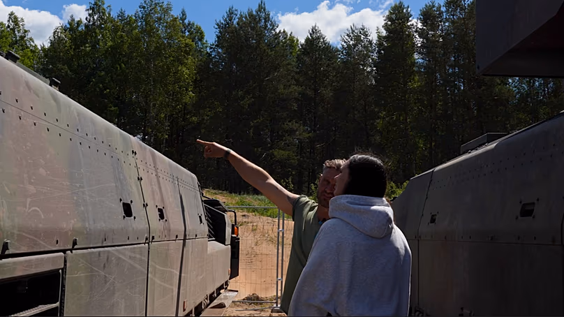 Philipp from mechanised infantry battalion 122 shows Lithuanian schoolgirl Kamilė the Puma before she is allowed to go for a ride in it.