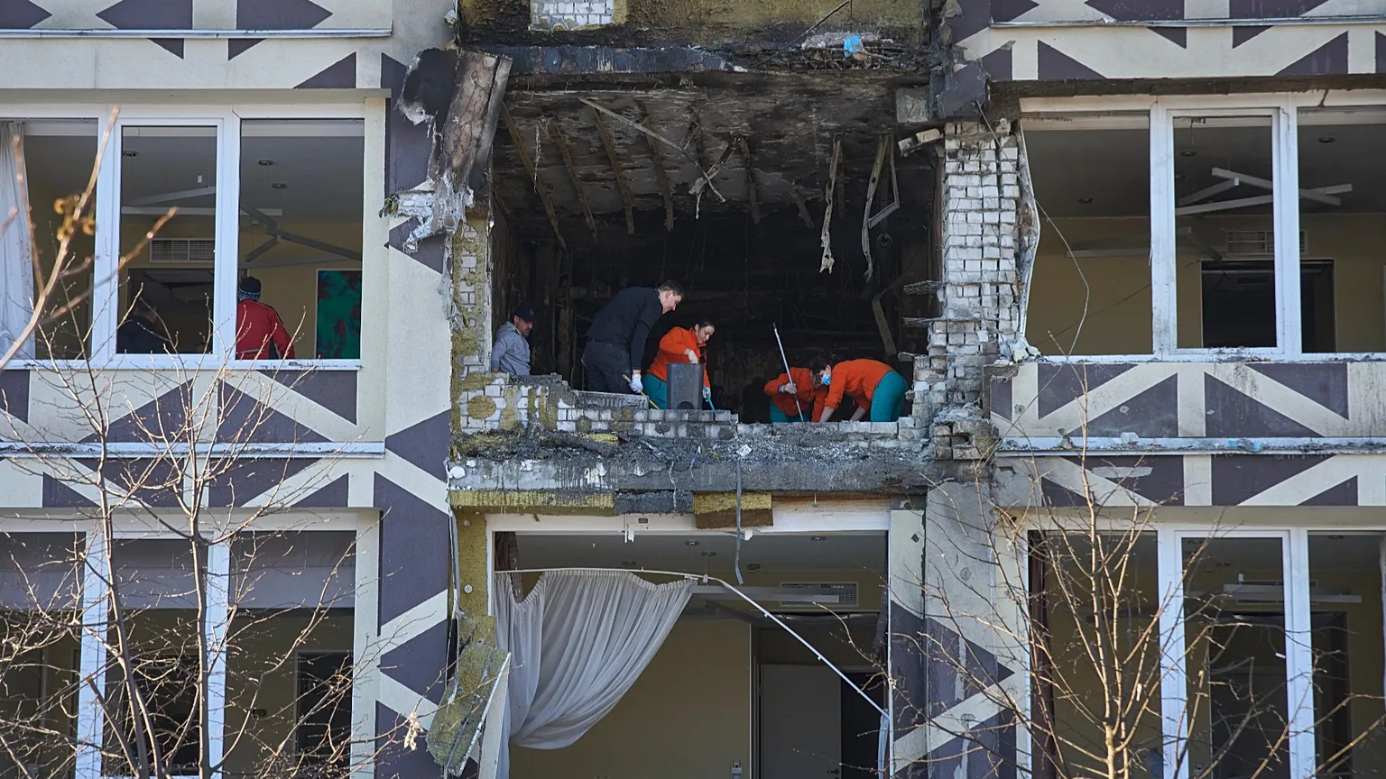 Medical workers remove the debris in a damaged private clinic after a Russian drone hit a hospital room killing a patient in Kyiv, 5 January, 2026