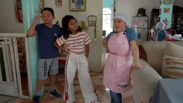 María del Cisne habla junto a su hija y su sobrino.
