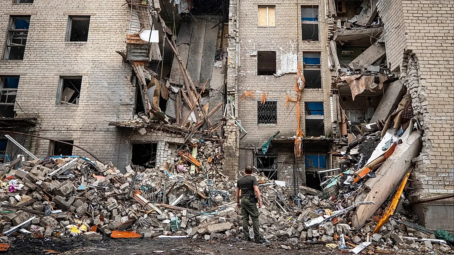 A Ukrainian serviceman looks at a residential building destroyed by a Russian missile strike in Sloviansk, Ukraine, Saturday, July 25, 2026.
