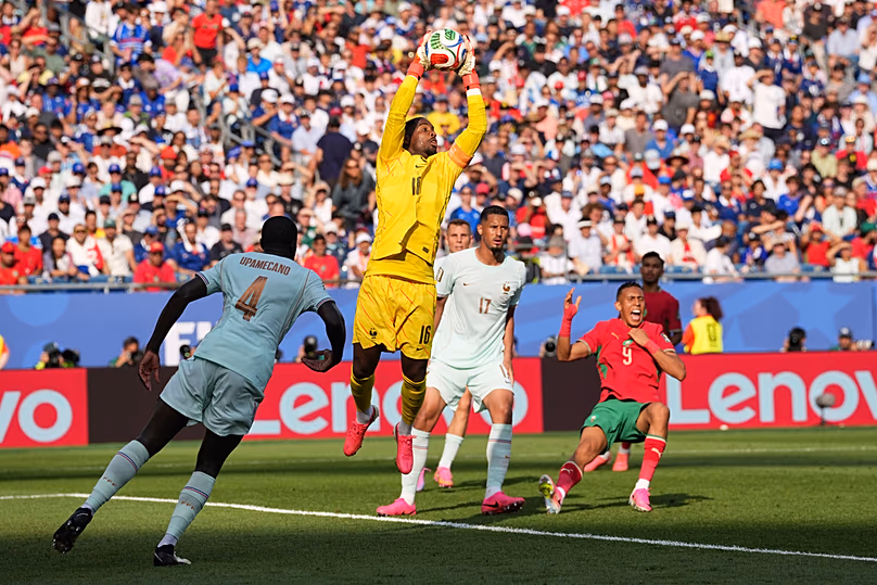 France goalkeeper Mike Maignan (16) makes a save during the World Cup quarterfinal soccer match between France and Morocco in Foxborough, Mass., near Boston, Thursday, July 9.