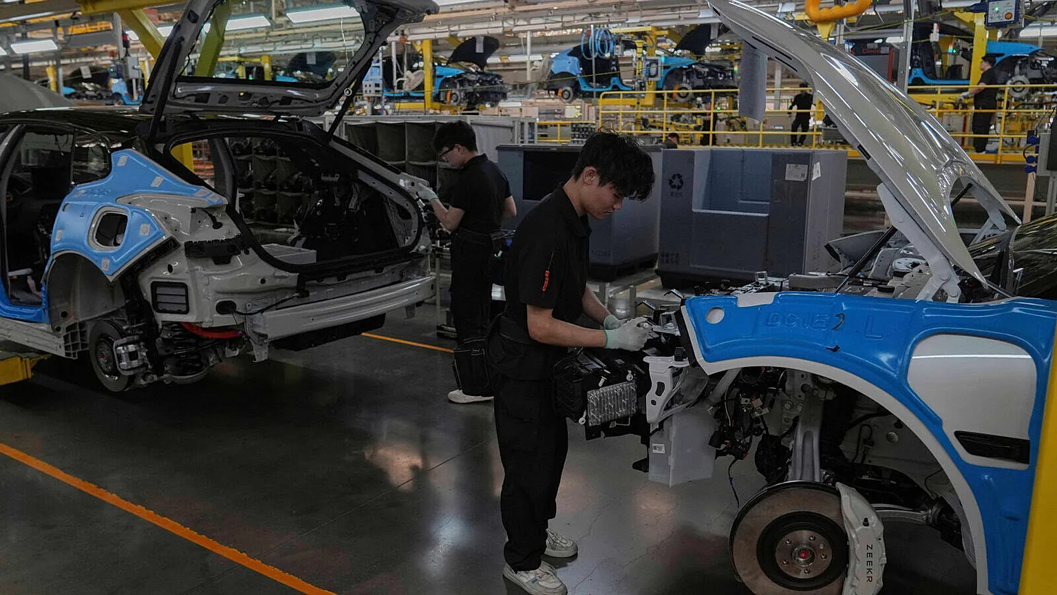 Workers assemble the Zeekr 001 EV models at the Chinese automaker Zeekr assembly plant in Ningbo, east China's Zhejiang Province, April 17, 2025