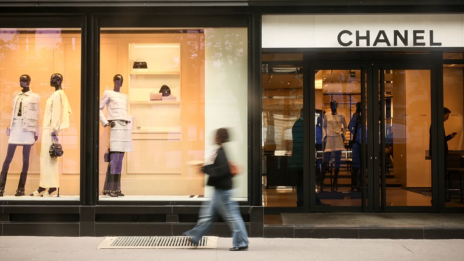 A woman walks past a Chanel shop, Monday, 28 July, 2025 in Paris.