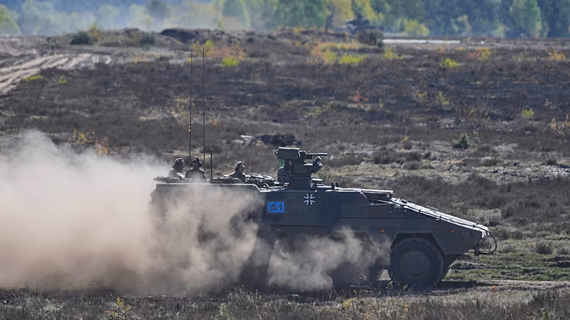 German Chancellor Friedrich Merz drives in an armoured fighting vehicle at the Bundeswehr base in Munster, Germany, Thursday, 30, April 2026.