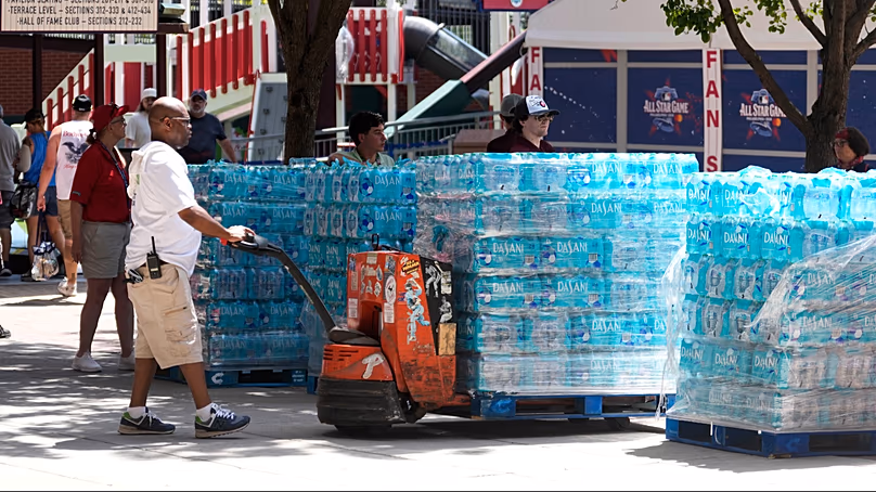 A worker stages water bottles to distribute. (AP Photo/Matt Slocum)