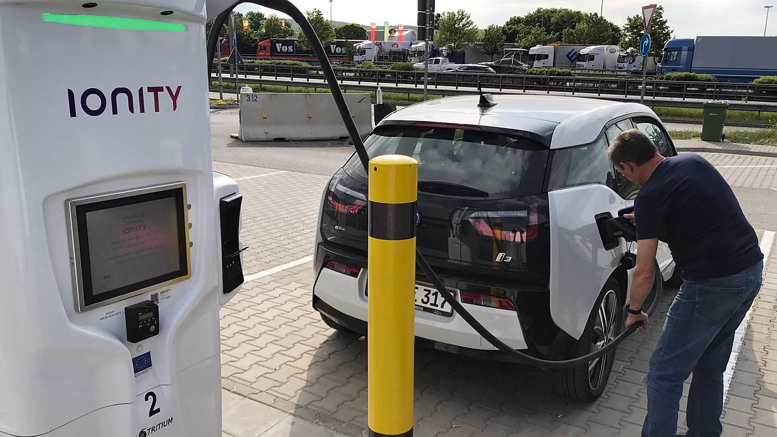 A man charges his BMW electric vehicle at the rest stop Brohltal Ost at the A61 motorway in Niederzissen, Germany, May 11, 2018.