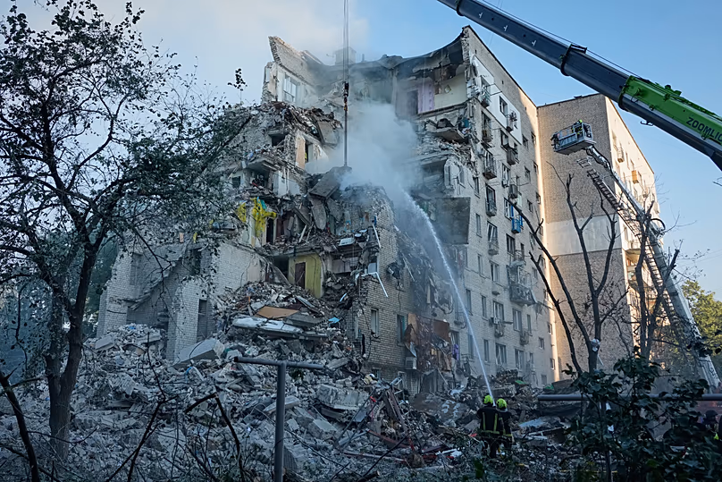 Emergency services personnel work to extinguish a fire after a Russian strike on Kyiv, 2 July, 2026