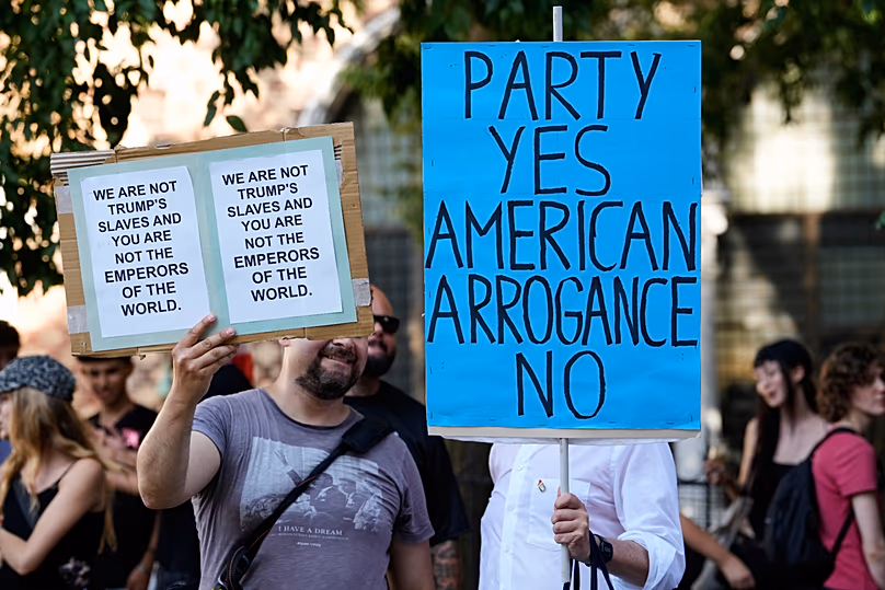 Demonstrators hold banners as they gather to protest against U.S. Ambassador Tilman Fertitta's superyacht 'Boardwall' presence in Venice, Friday, 17 July, 2026.