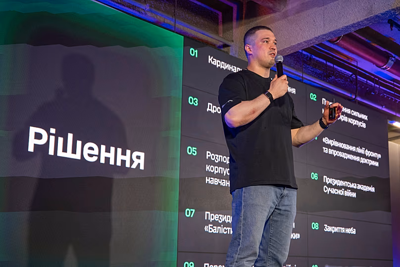 Minister Mykhailo Fedorov speaks during a briefing to journalists in Kyiv, Ukraine, Thursday, July 16, 2026. The sign on left reads "Decisions".