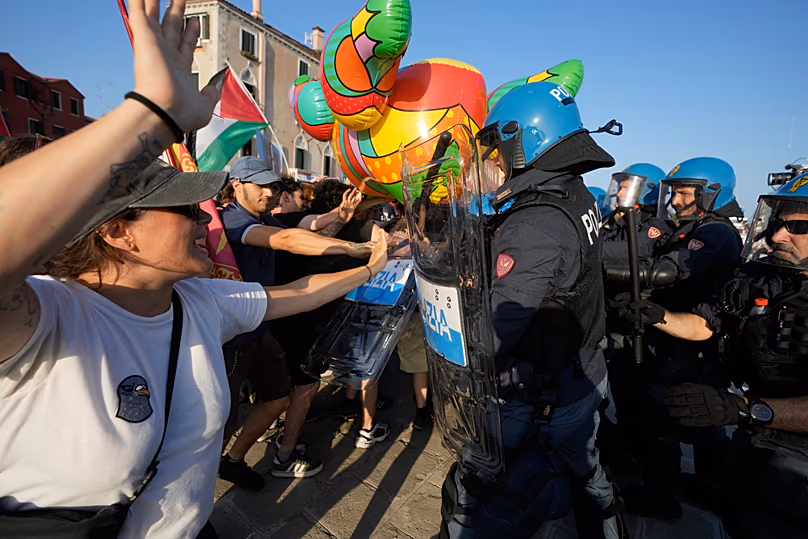 Police officers confront demonstrators gathered to protest against U.S. Ambassador Tilman Fertitta's luxury yacht 'Boardwalk" presence in Venice, Friday, 17 July, 2026.