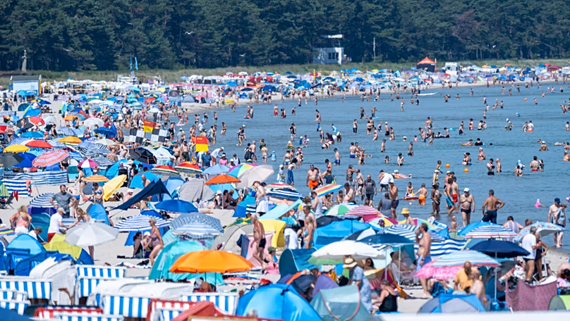 People crowd the beach at the seaside resort on the island of Rügen, 27 June, 2026