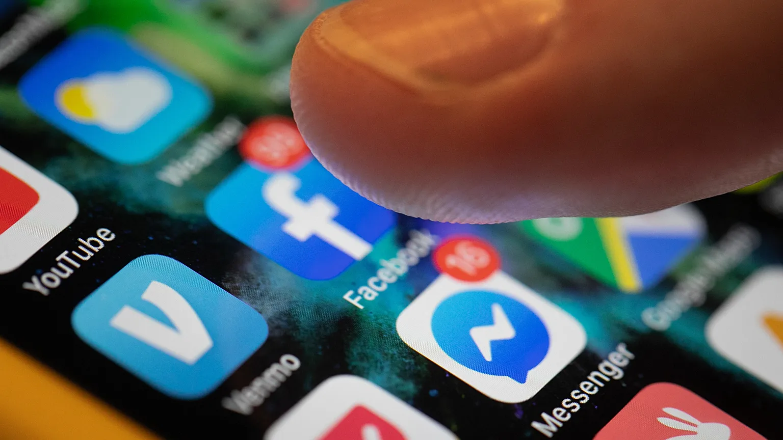 An iPhone displays the apps for Facebook and Messenger